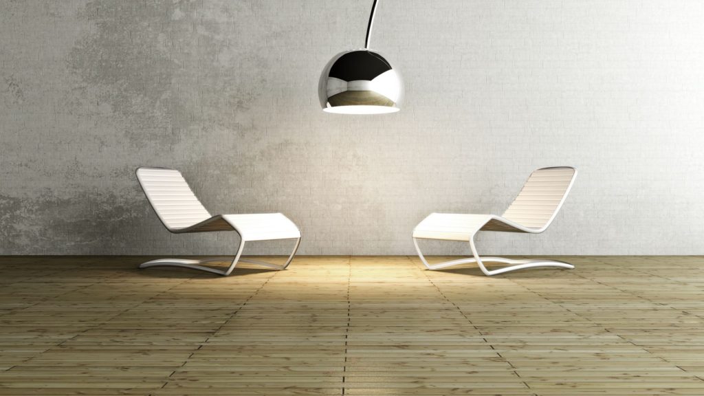 Two white chairs and a lamp in the middle of a room.