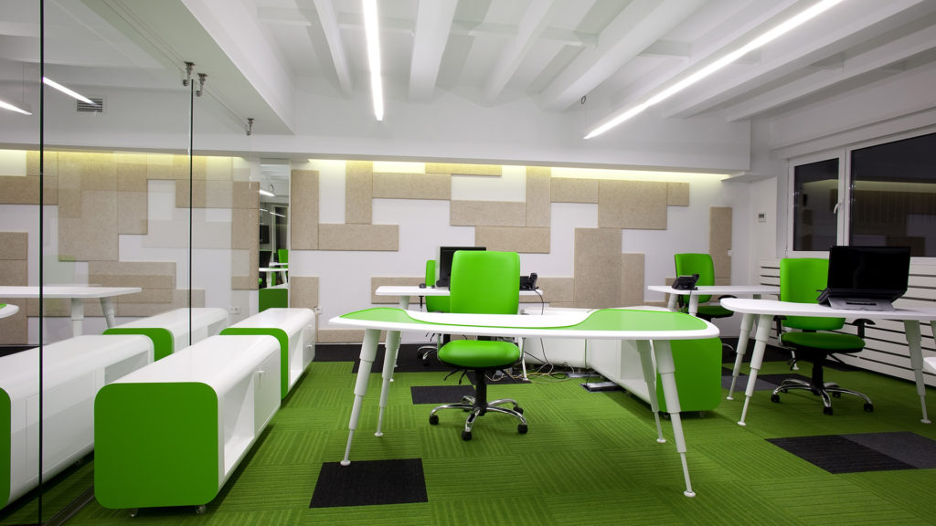 A green office with white walls and carpet.